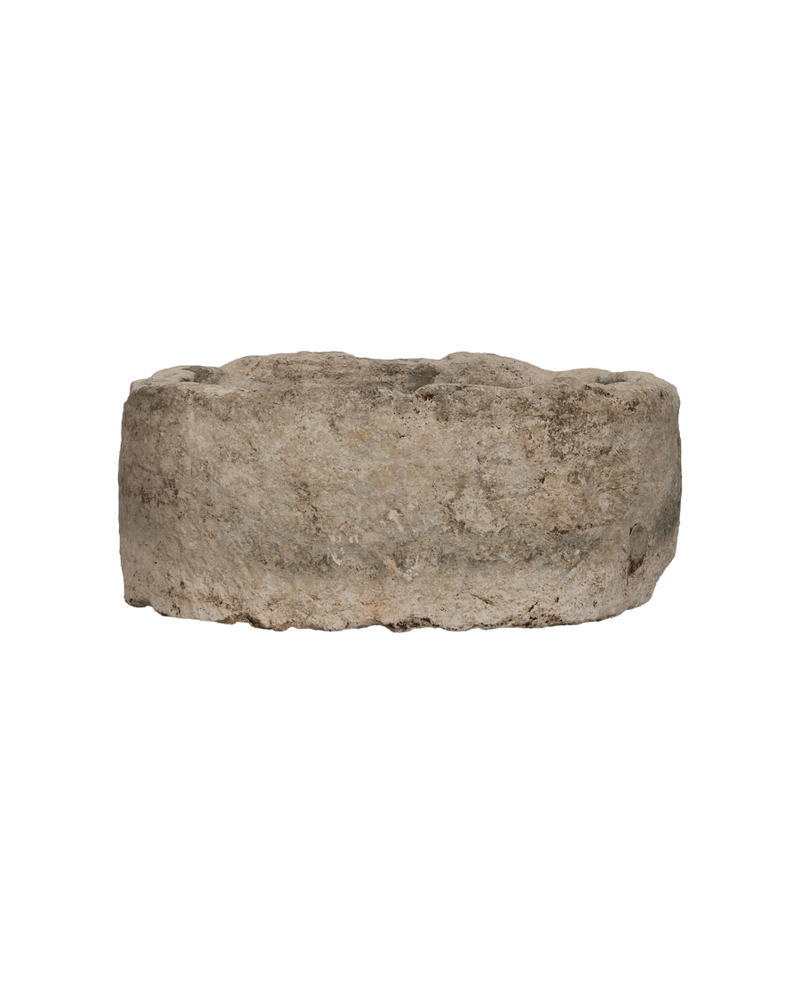 Vintage Indonesian oblong limestone trough, weathered surface texture close-up.