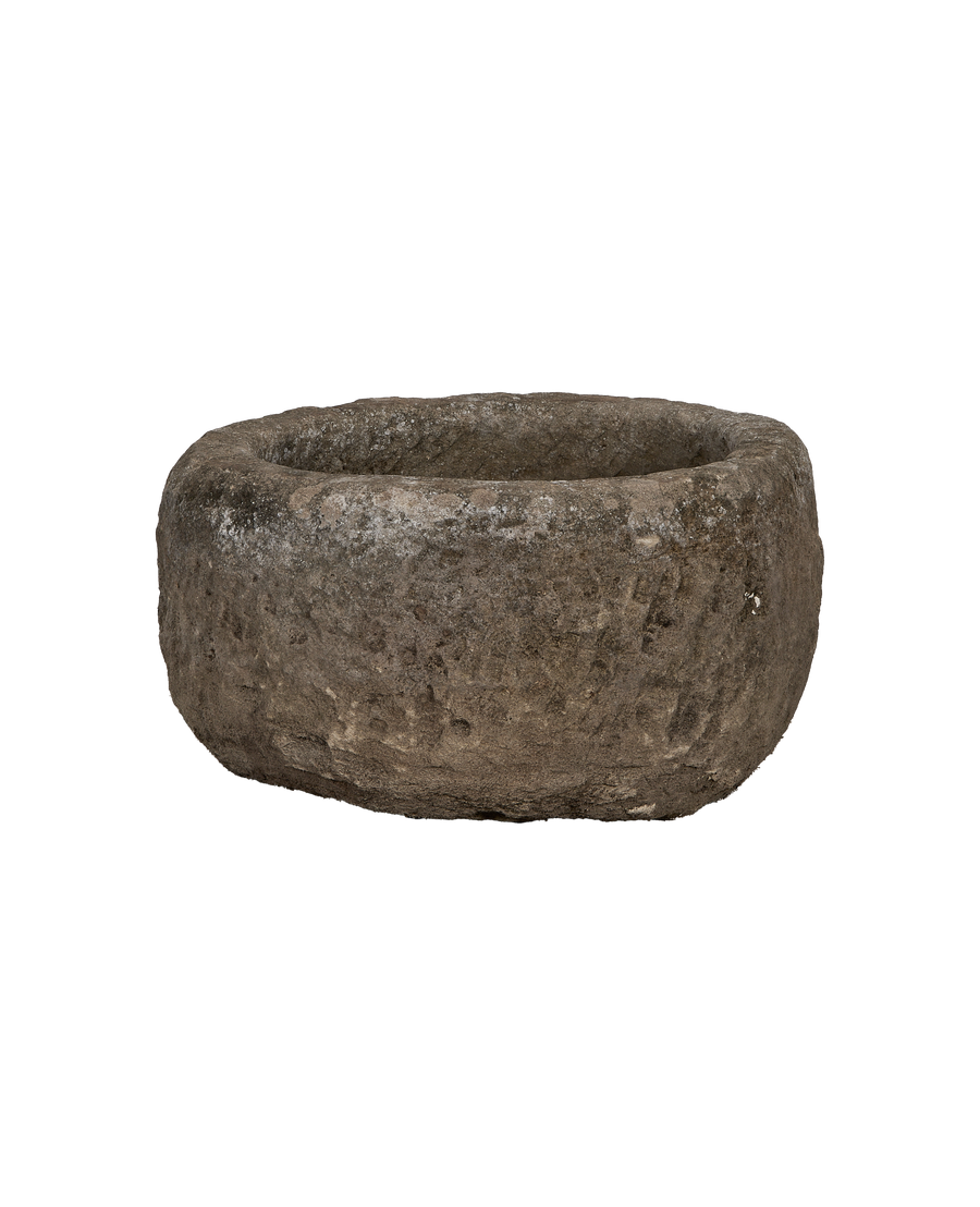 Vintage Indonesian limestone trough, round, showcasing rough textured surface with natural imperfections.