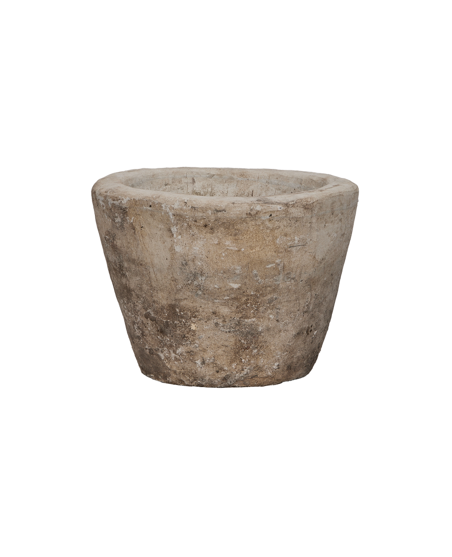 Vintage Indonesian round limestone trough, showing weathered texture from an elevated angle.
