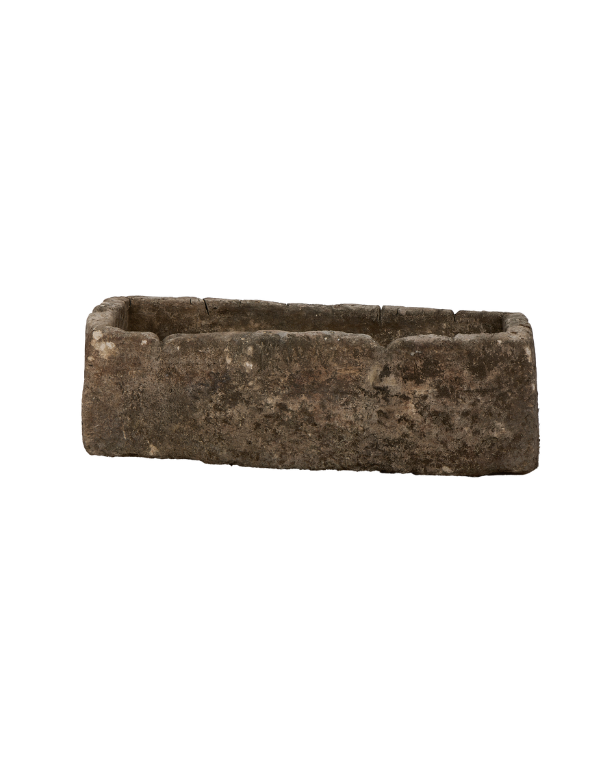 Vintage Indonesian limestone trough viewed from inside, showing rough texture and weathered finish.