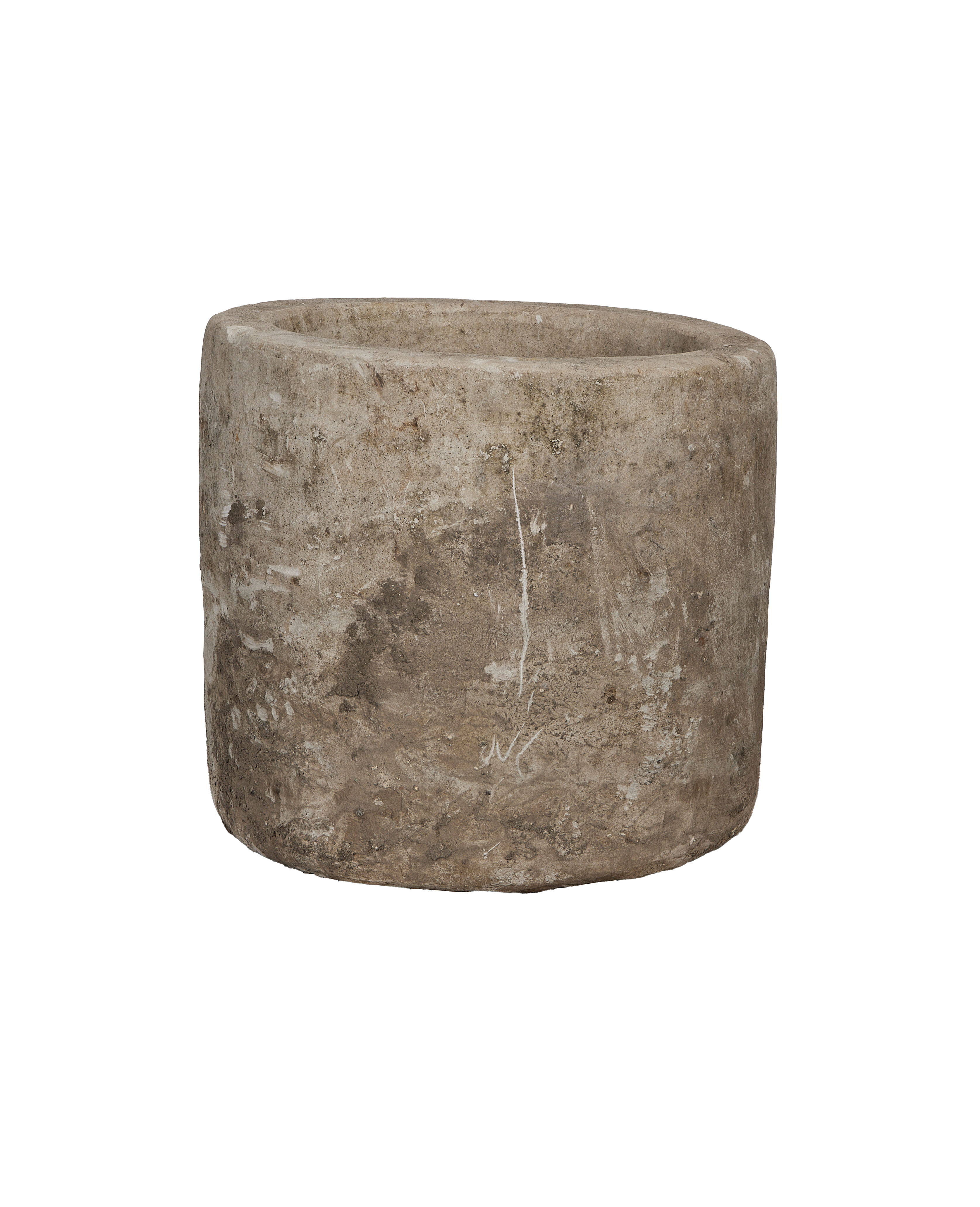 Vintage Indonesian limestone trough, round, showing worn, textured exterior from slightly elevated angle.