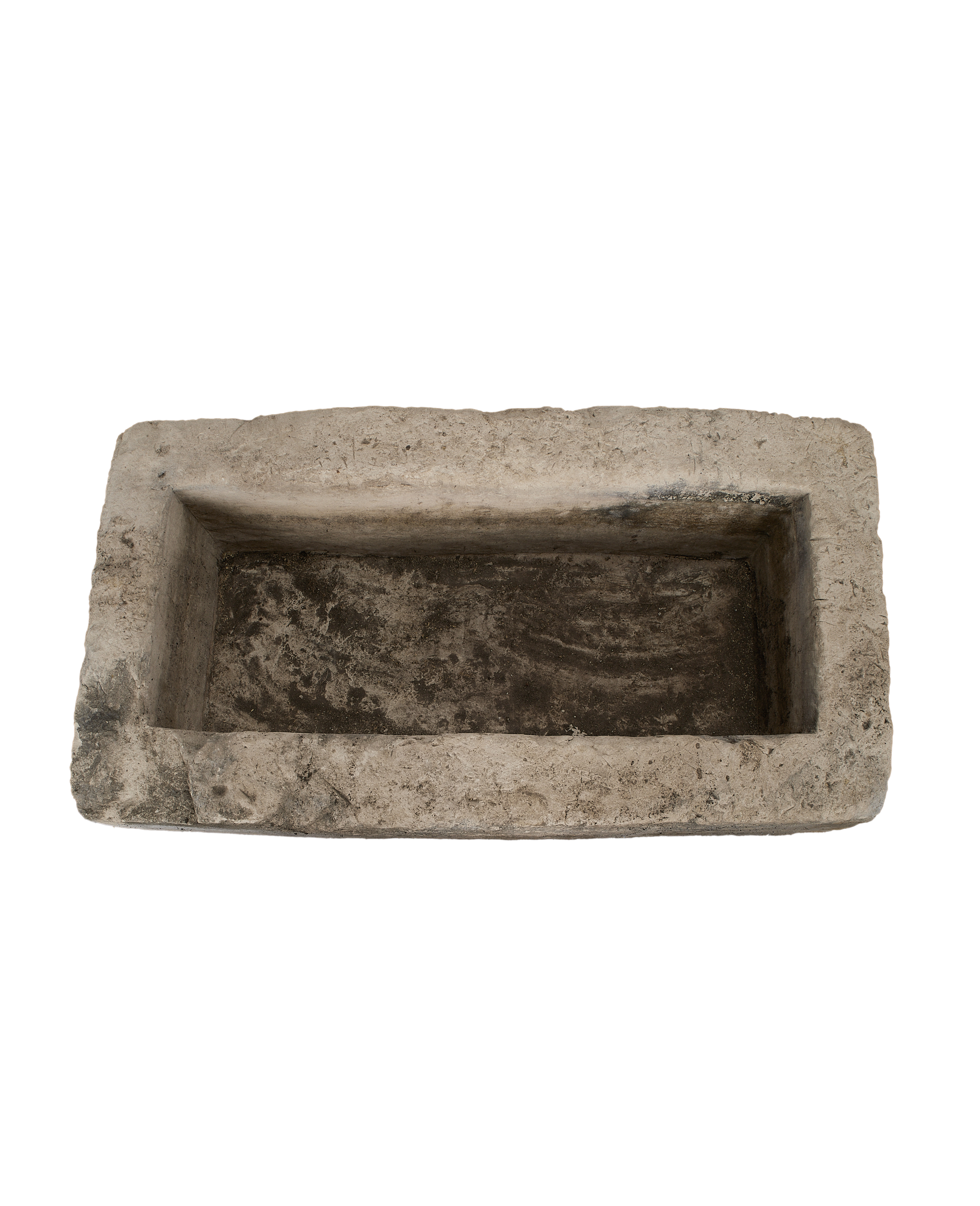 Vintage rectangular limestone trough, showing the rustic, rough interior with dark stains.