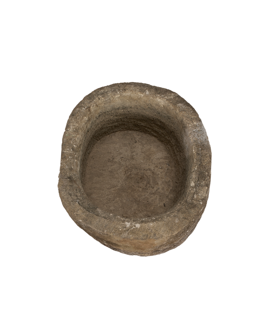 Vintage Indonesian limestone trough, top down view highlighting oblong basin depth and texture.