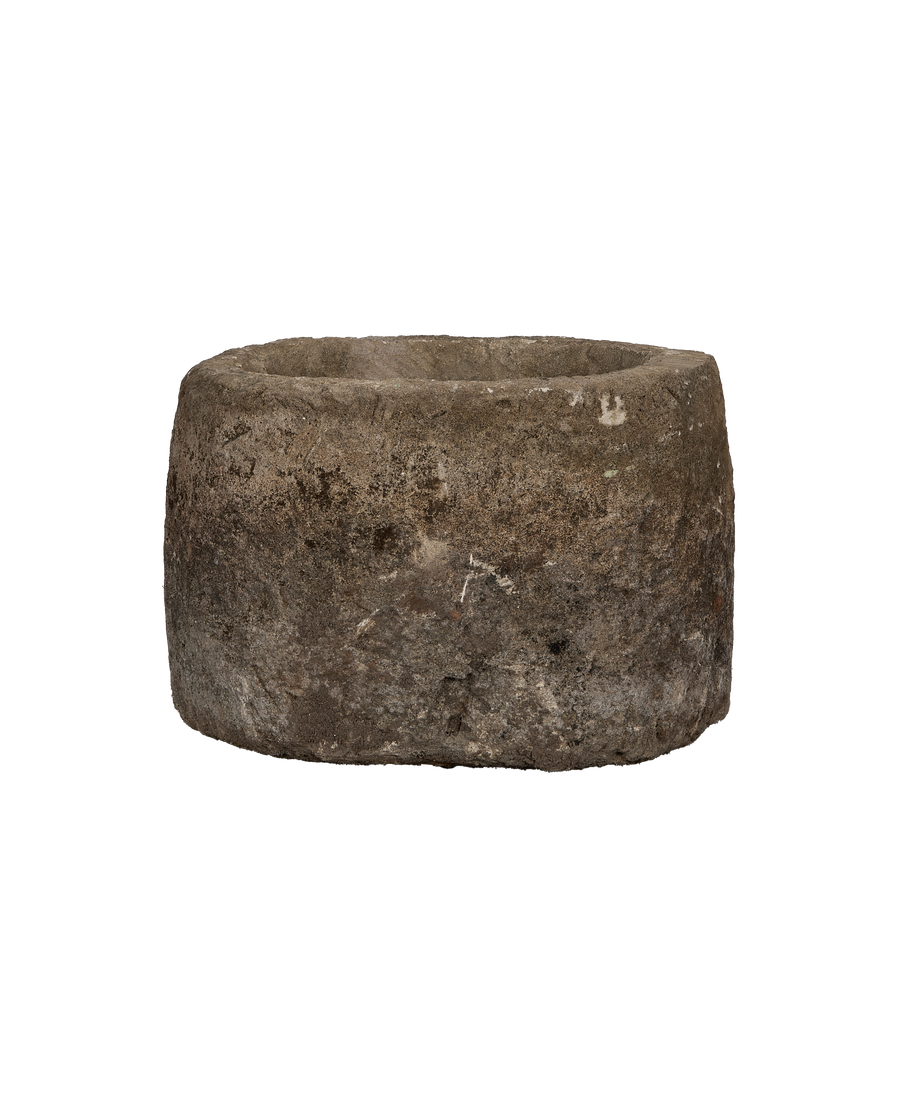 Vintage Indonesian oblong limestone trough, detailed weathered texture and round rim, front view.