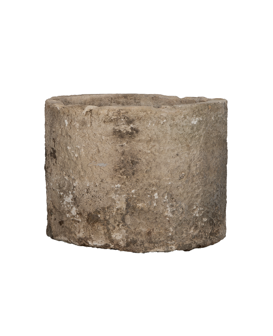 Vintage Indonesian round limestone trough, close-up of textured surface with weathered details.