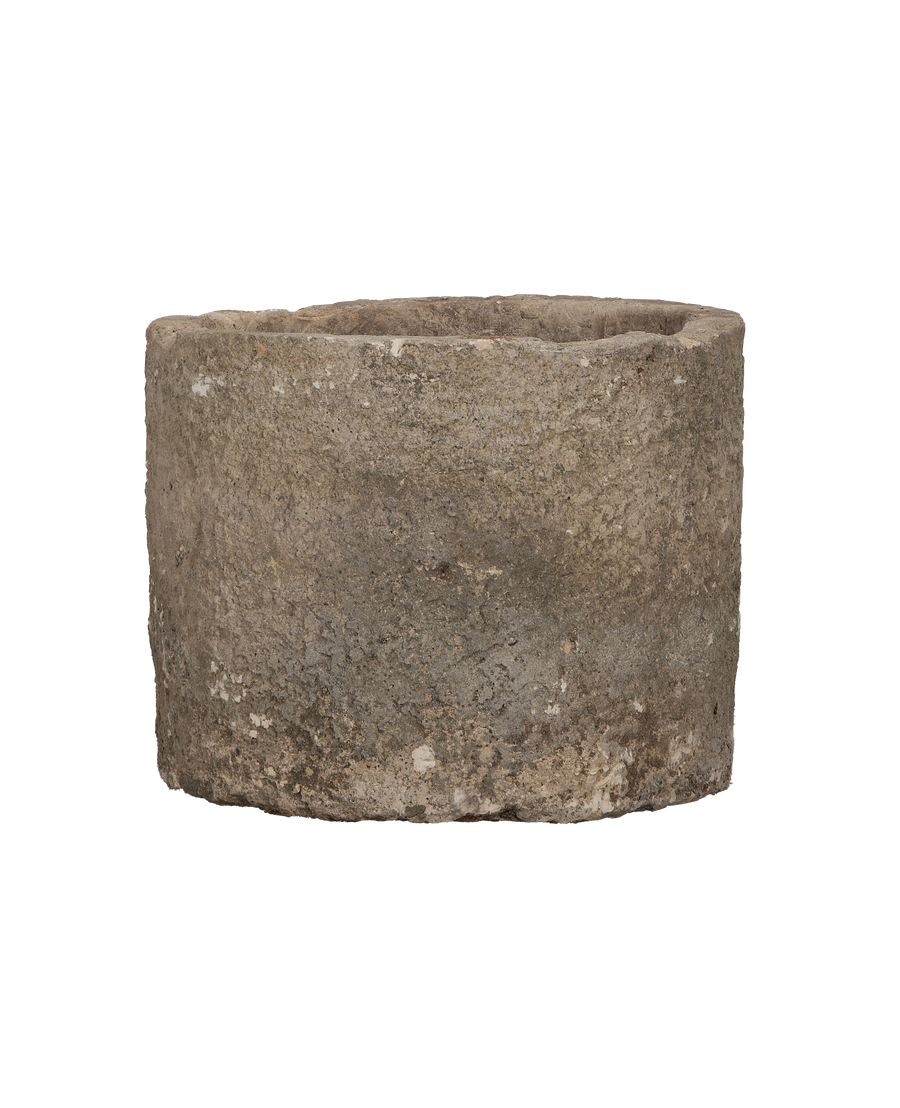 Vintage Indonesian limestone trough closeup, featuring rough texture and weathered top edge detail.