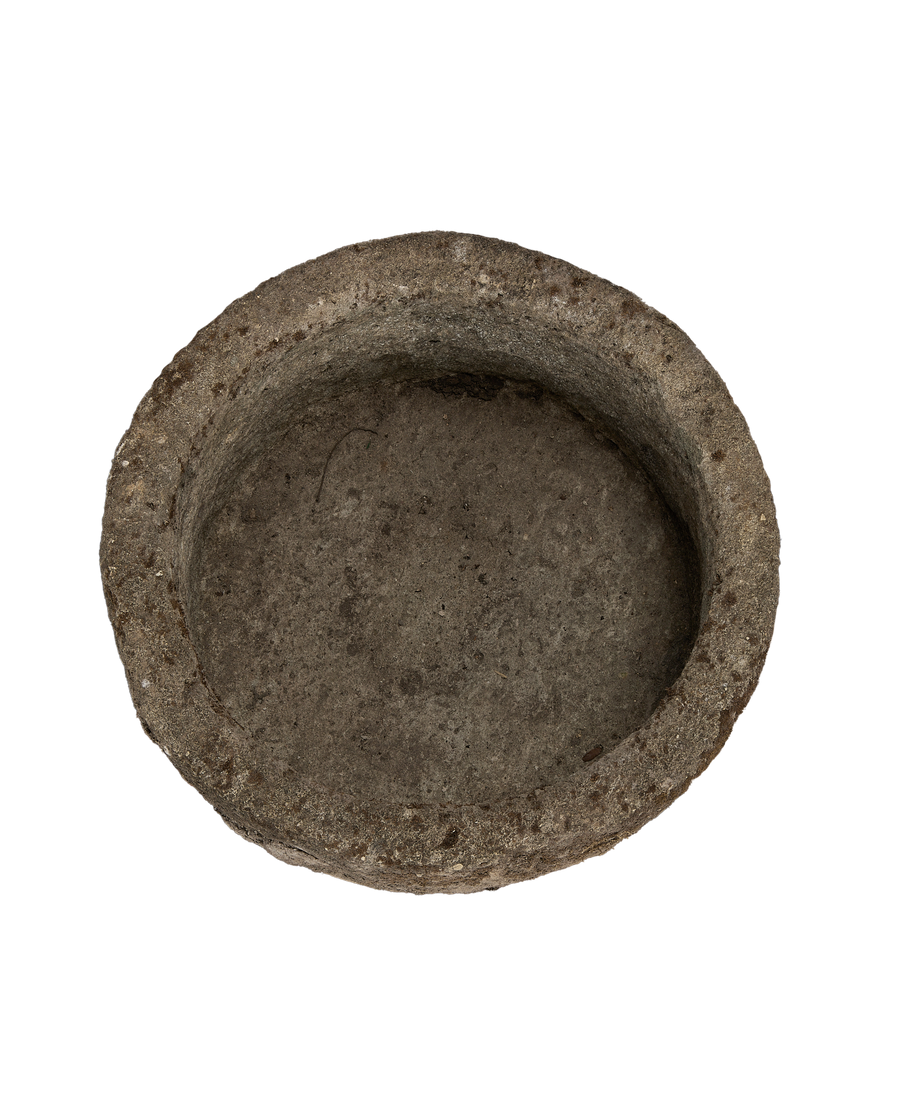 Top-down view of a vintage round limestone trough from Indonesia, weathered surface.