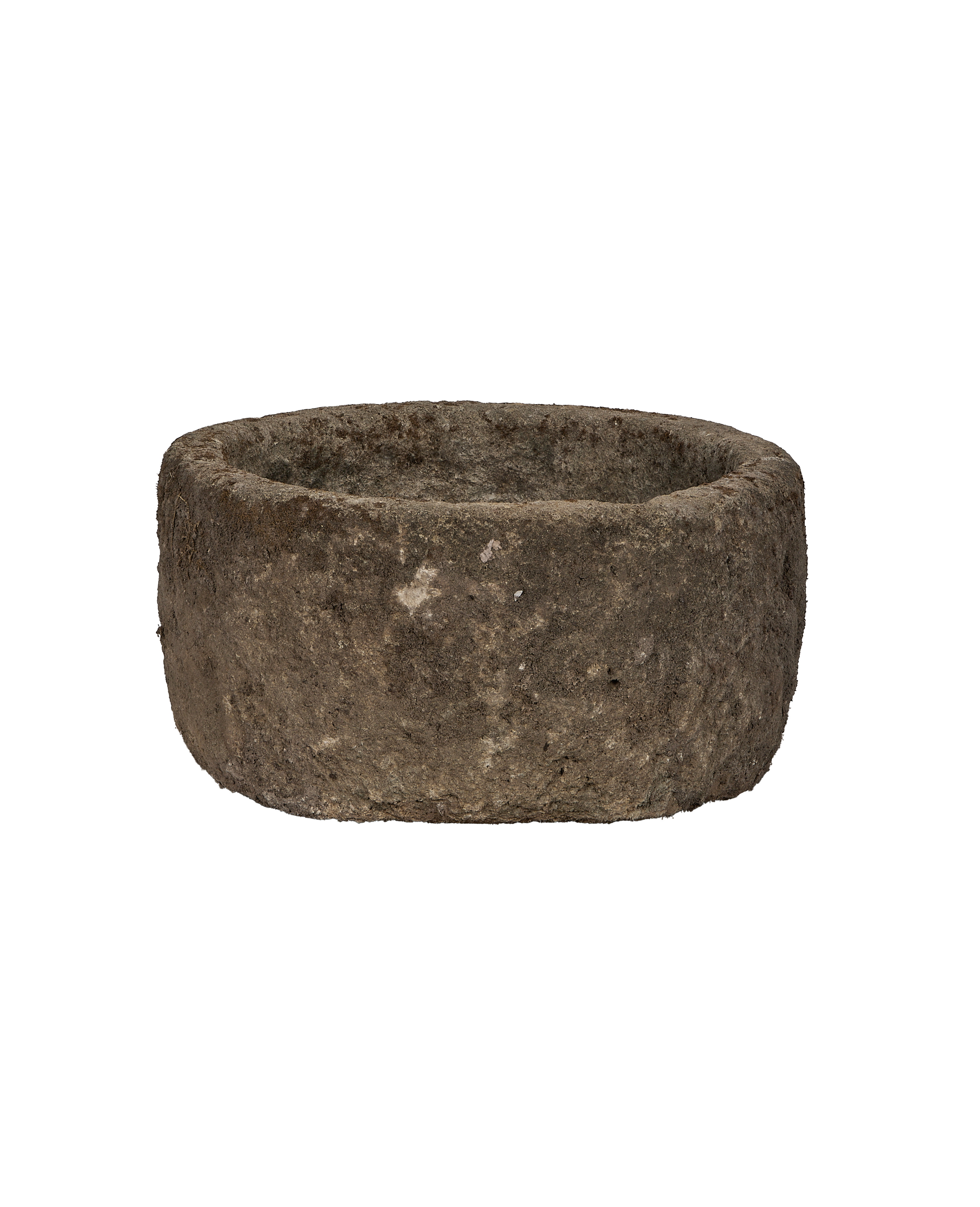 Vintage round limestone trough, showing rough weathered Indonesian texture and uneven rim detail.