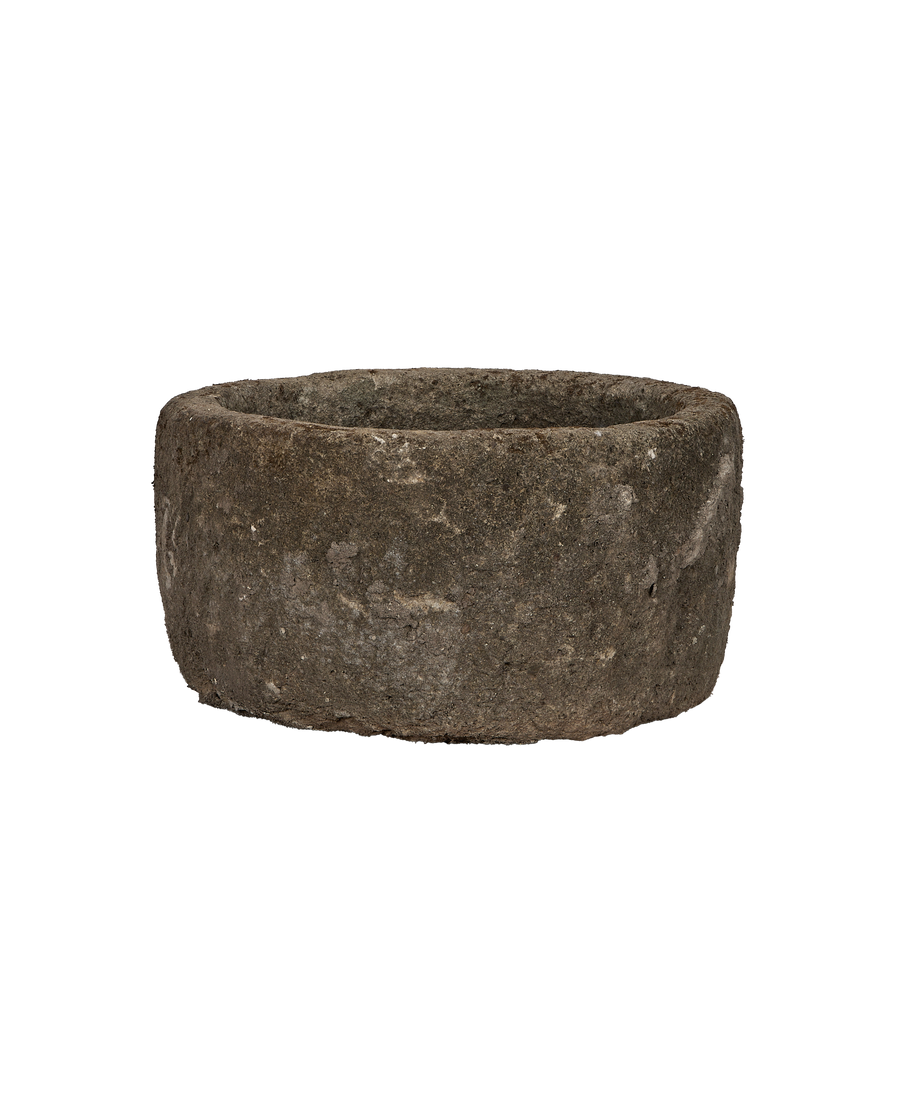 Vintage round limestone trough from Indonesia, showing rough texture and weathered finish.