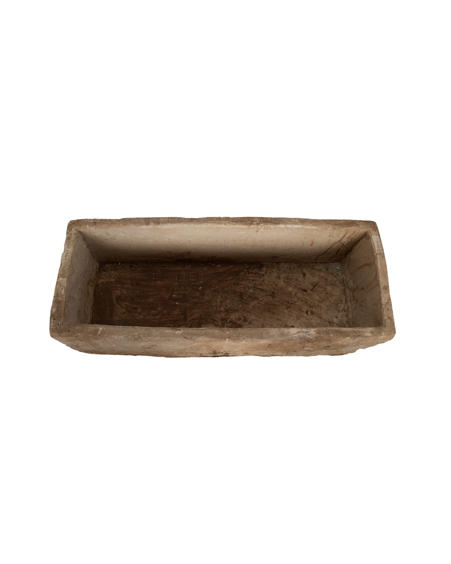 Vintage rectangular limestone trough, showing the rustic, textured interior basin and weathered rim.