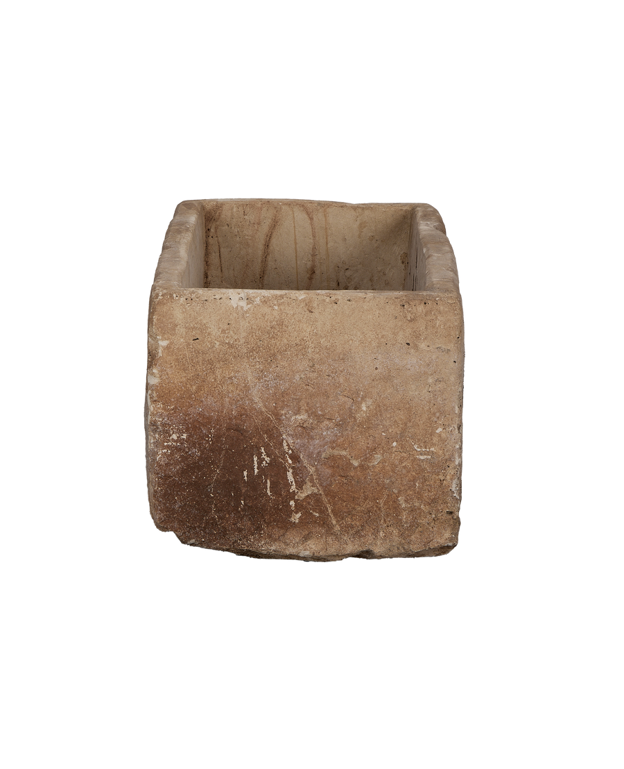 Vintage Indonesian limestone trough, top opening detail, rough textured surface, weathering around rim.