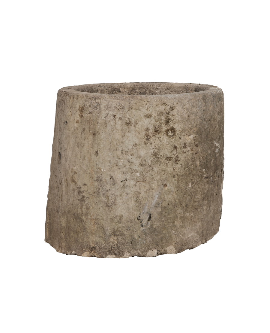 Vintage Indonesian limestone trough, round, showing detailed texture and natural imperfections on its rough surface.
