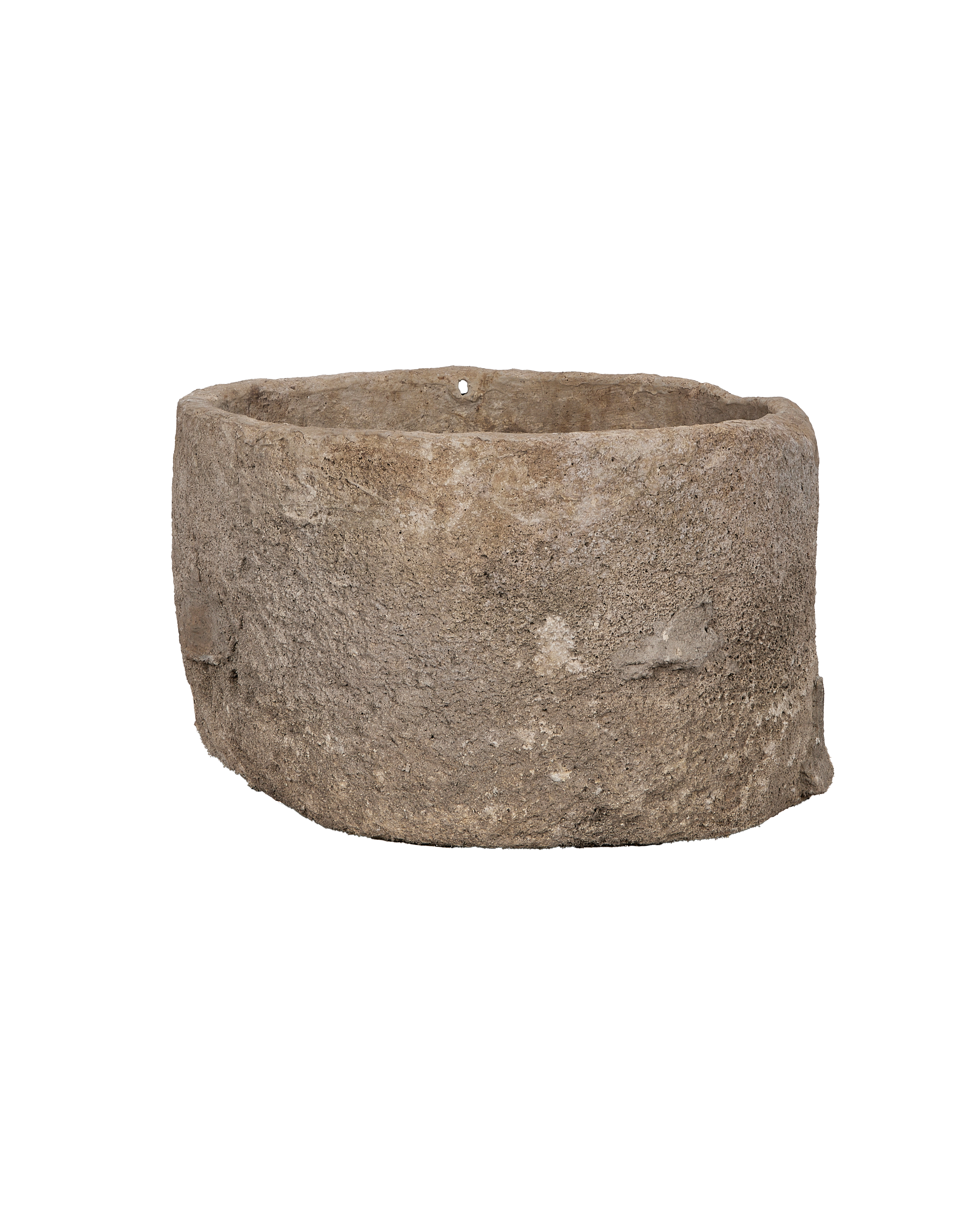 Vintage round Indonesian limestone trough exterior, showcasing textured surface and worn edges from angled view.