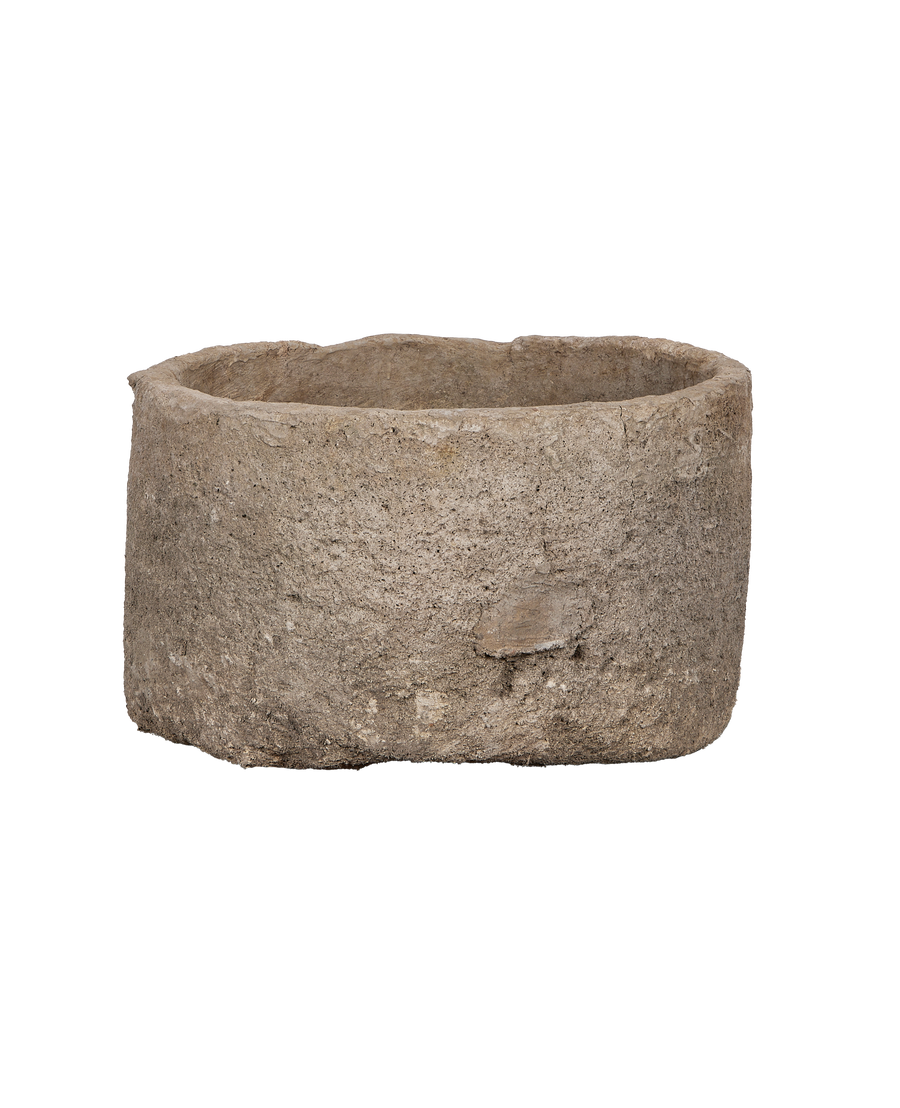 Vintage Indonesian round limestone trough, side angle showcasing raw textured surface and rough-cut edges.