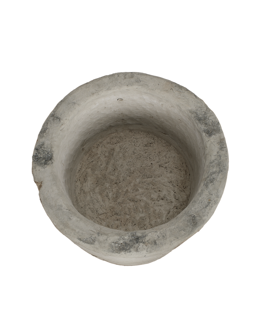 Vintage round Indonesian limestone trough, top-down view showing interior texture and rim chips.