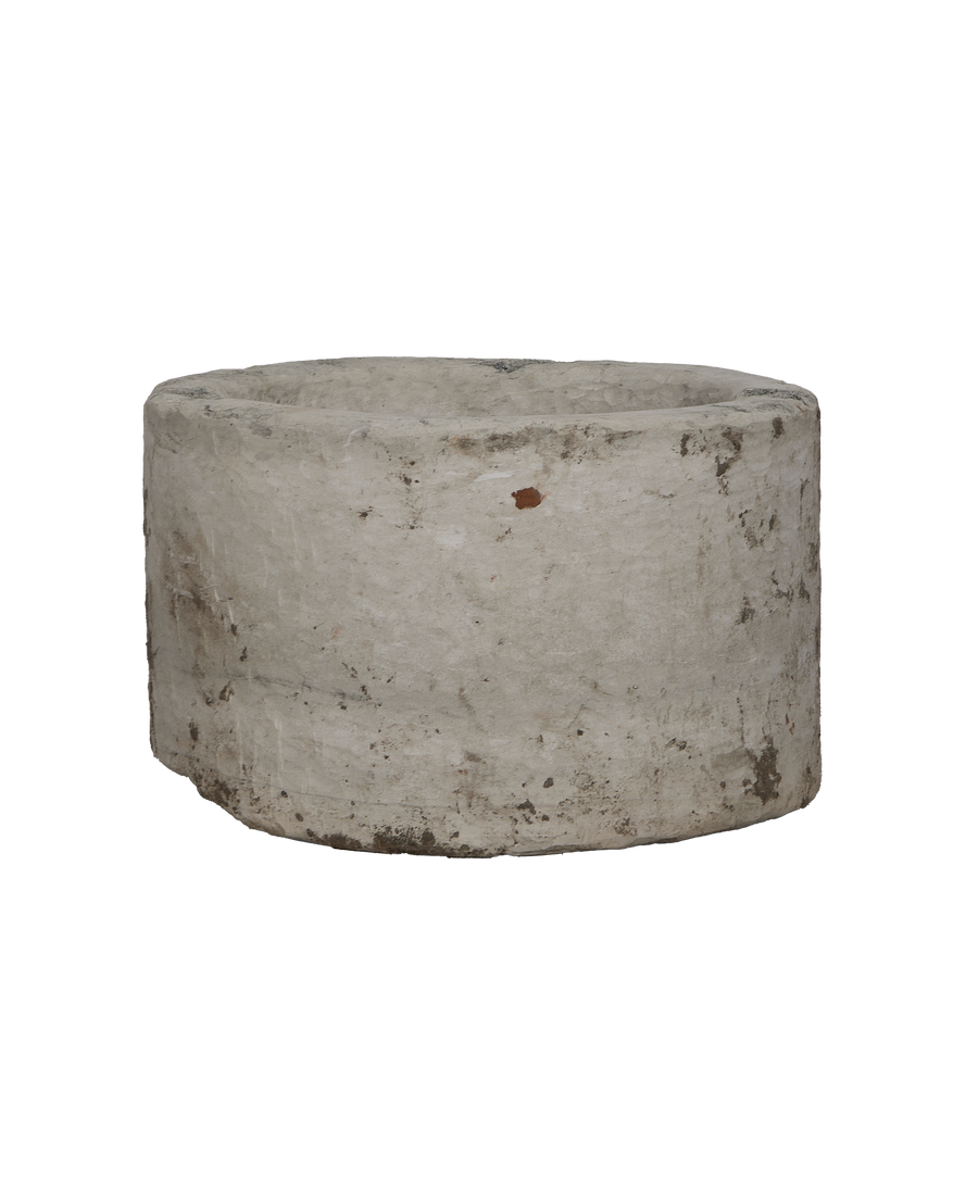 Vintage round Indonesian limestone trough, showing its weathered texture and sturdy, rustic circular form.