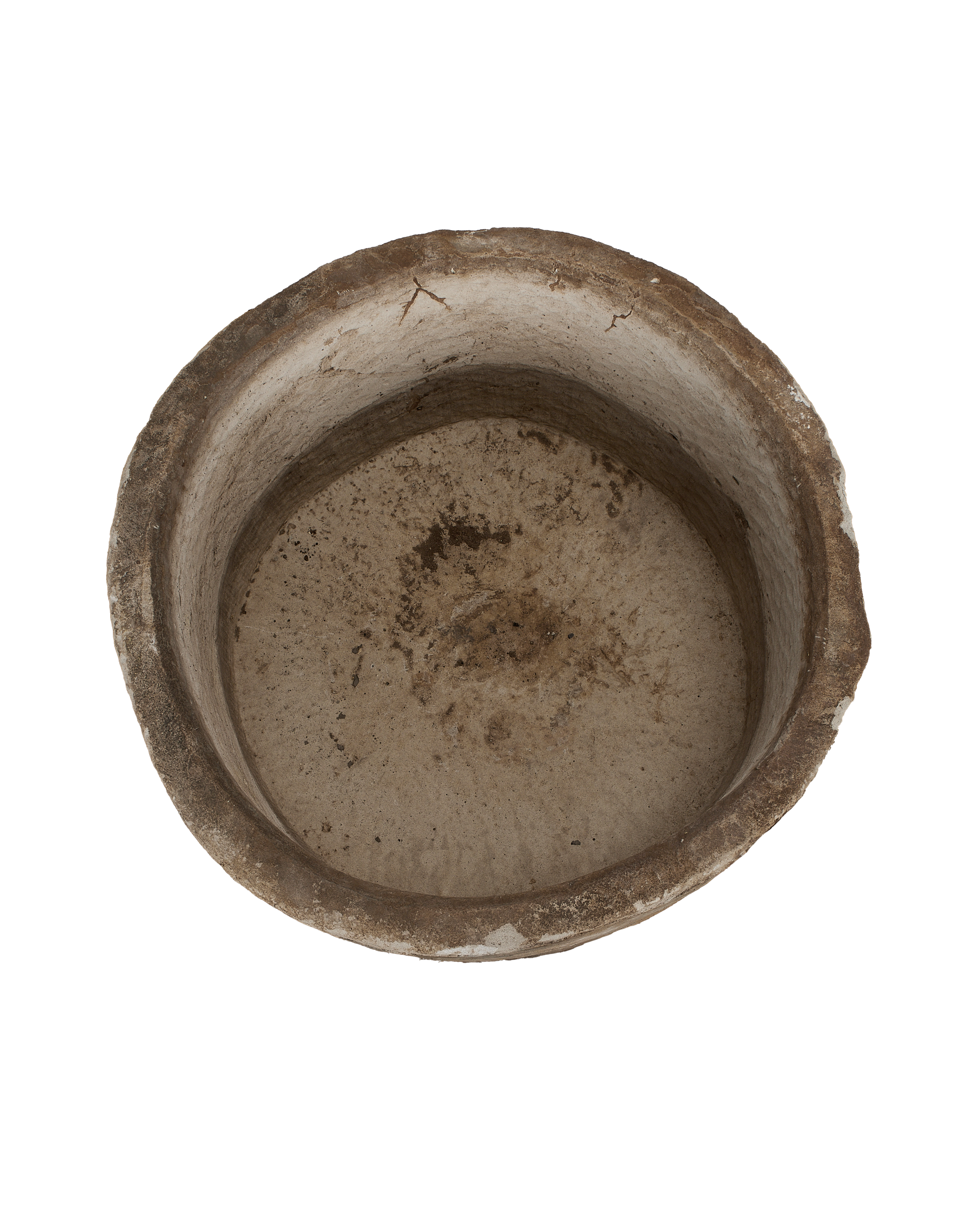 Vintage Indonesian round limestone trough, top view revealing weathered interior texture and cracks.