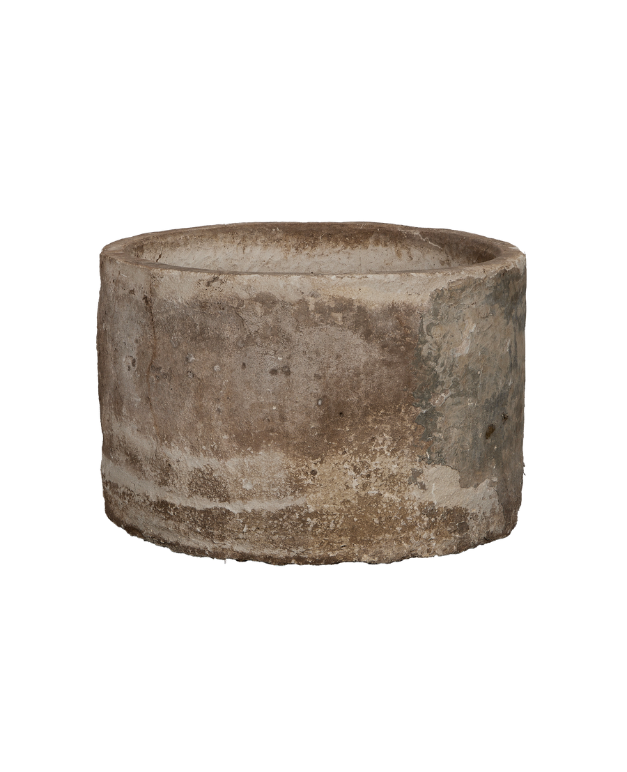 Vintage round Indonesian limestone trough, showing weathered texture and natural gray-brown patina.