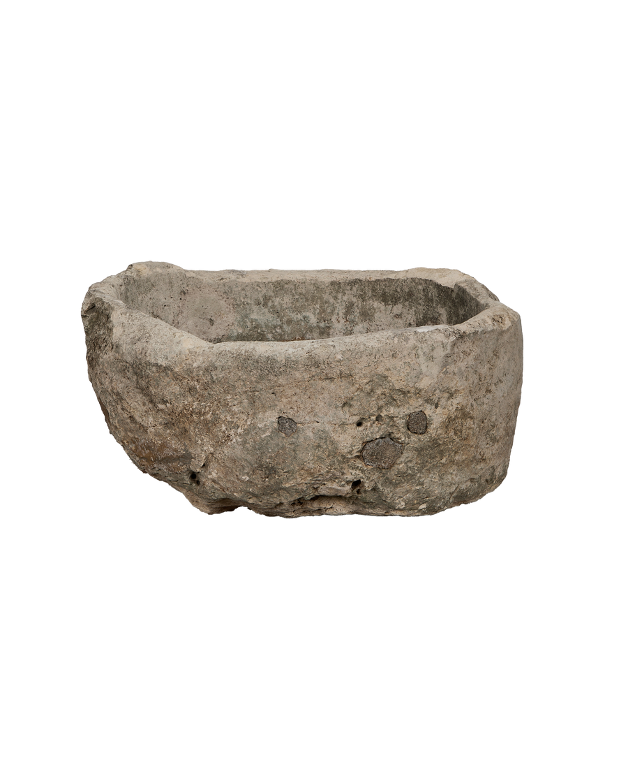 Vintage Indonesian oblong limestone trough, detailed texture and rough-hewn edges, high angle view.