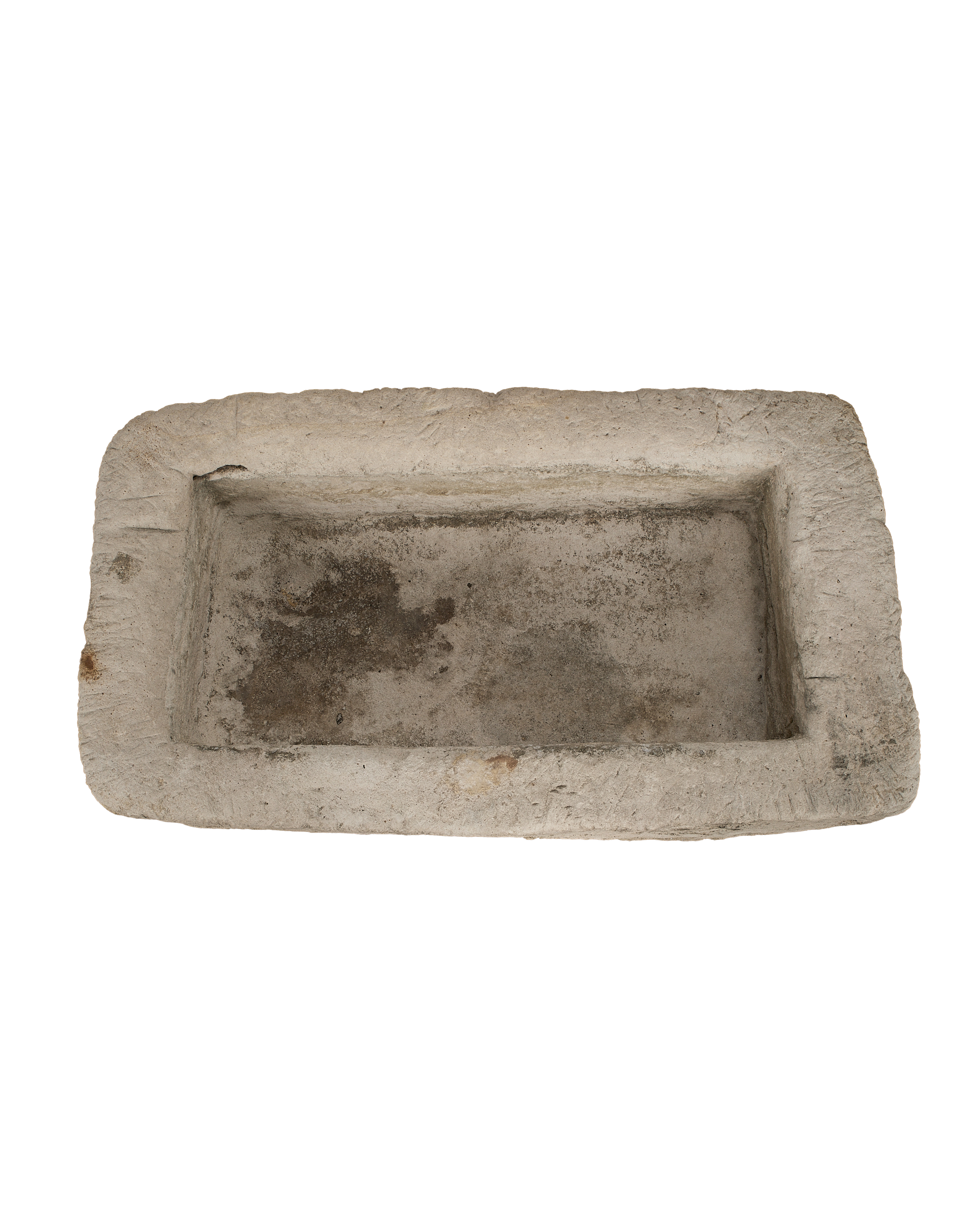 Vintage Indonesian limestone trough closeup, showcasing rough textured edges, weathered patina, and rectangular interior.