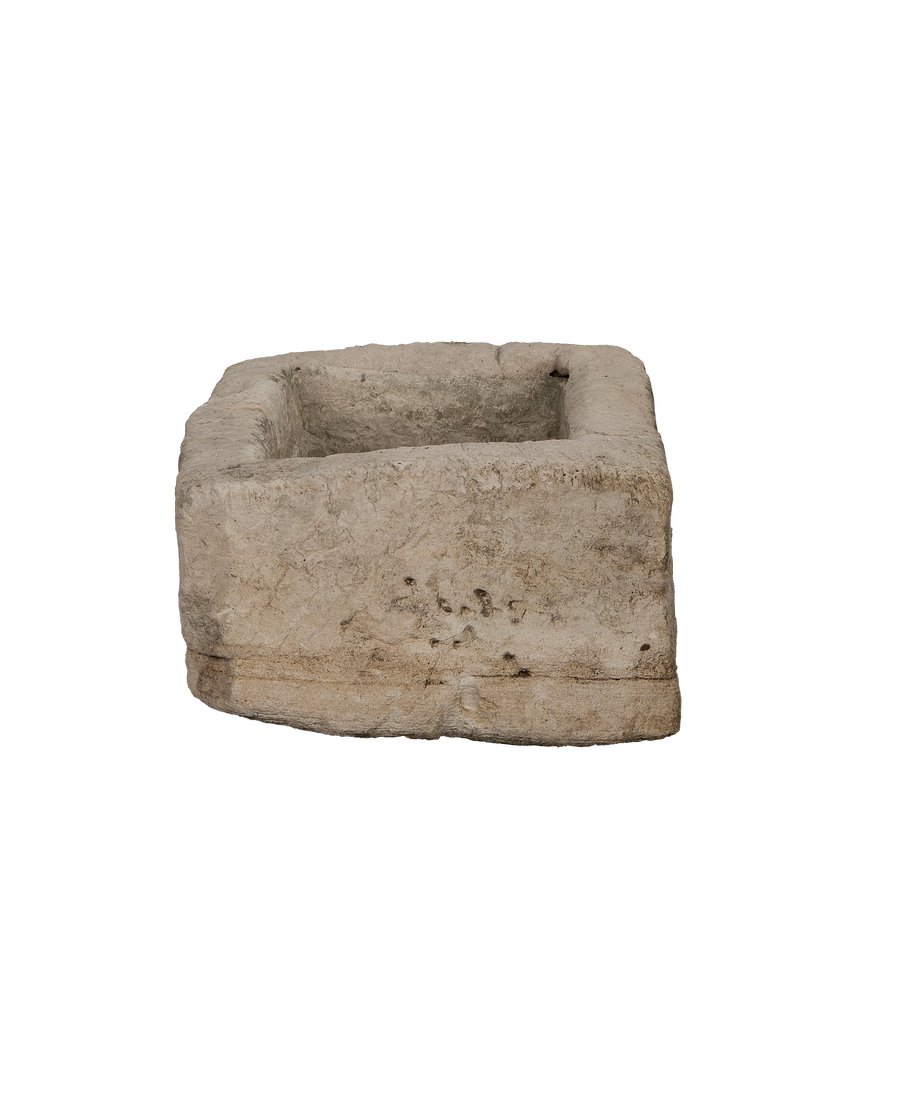 Vintage Indonesian limestone trough, rectangular, revealing textured surface and worn bottom edge.