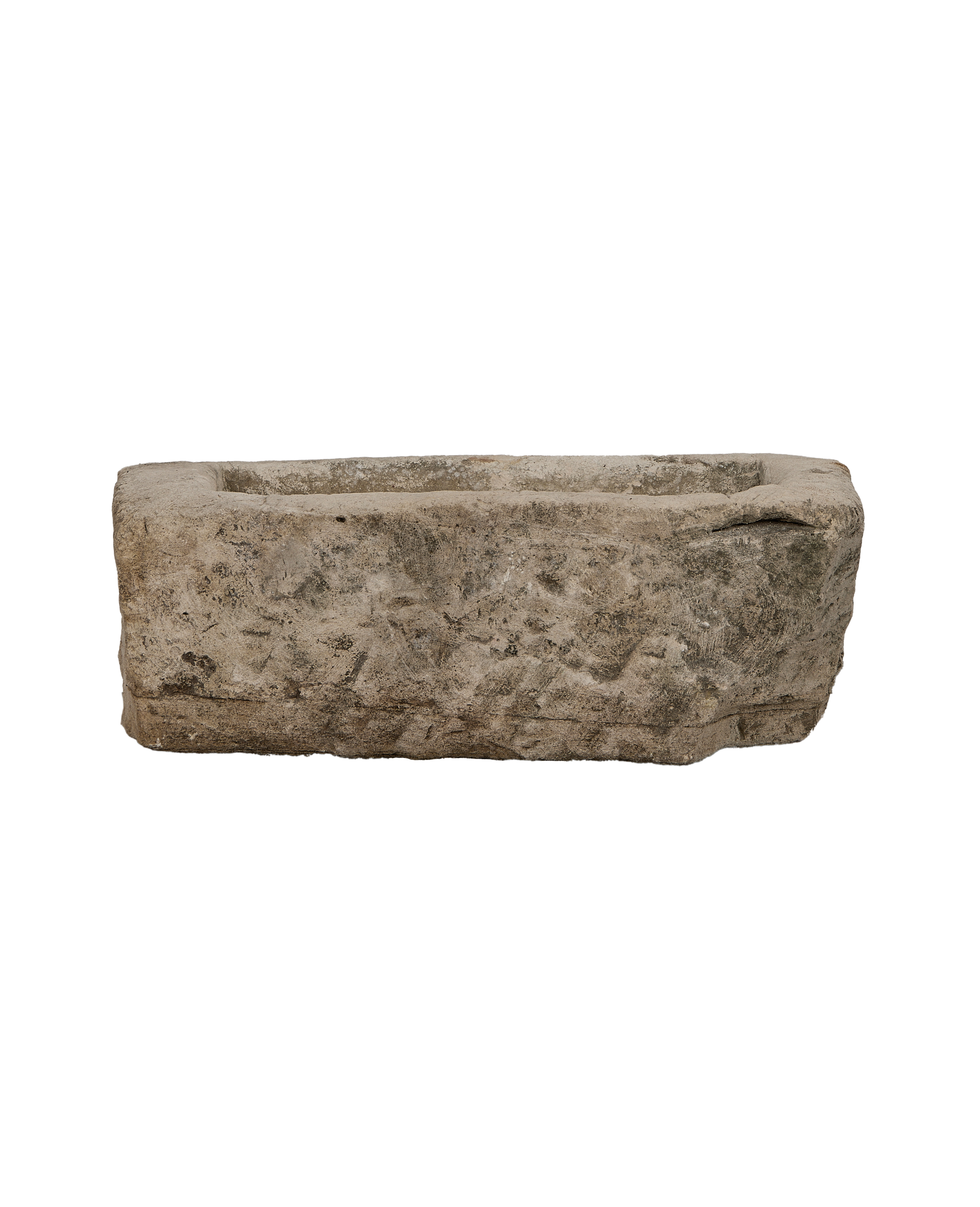 Vintage rectangular limestone trough, showing its aged, weathered surface texture from a side view.