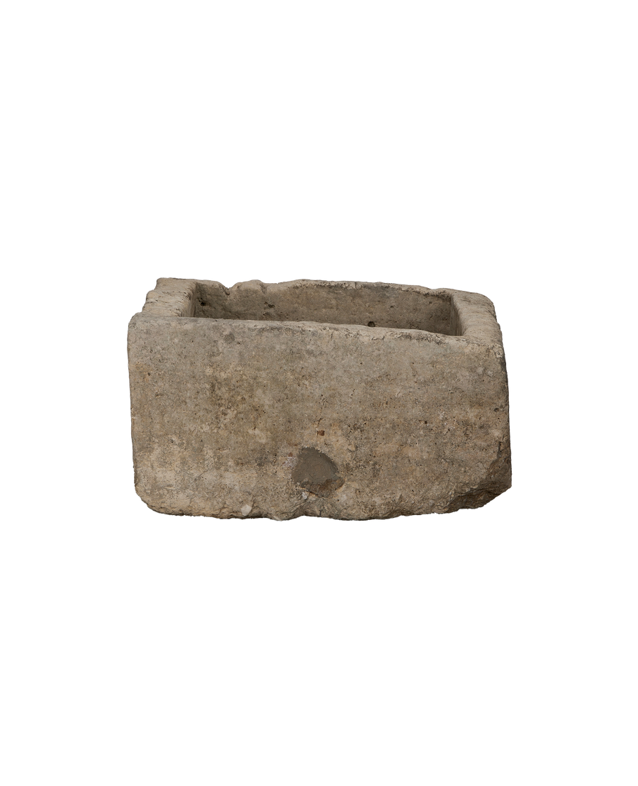 Vintage Indonesian limestone trough, rectangular, from a low-angle showing its weathered texture.