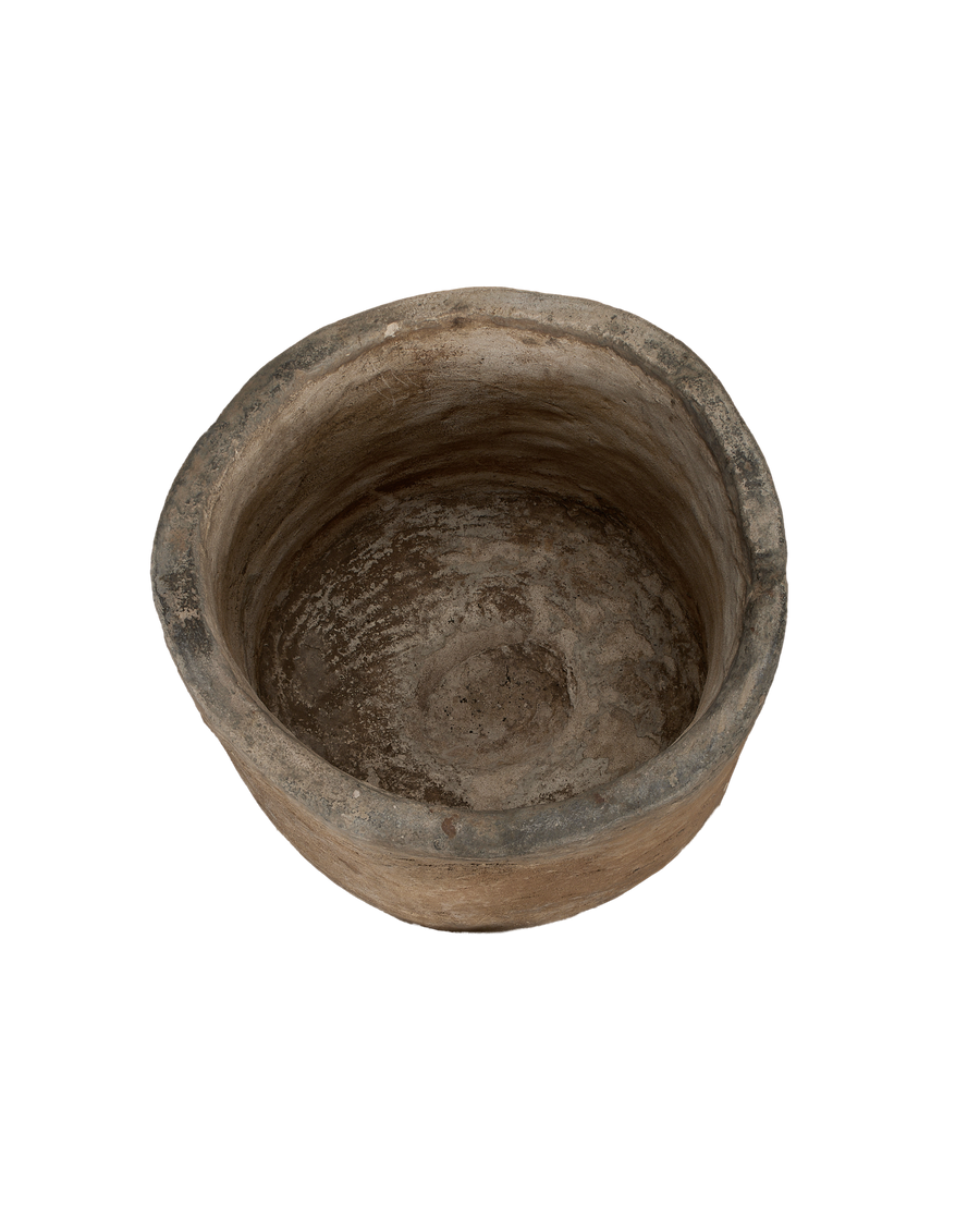 Vintage Indonesian round limestone trough, top-down view showing weathered interior texture and age.