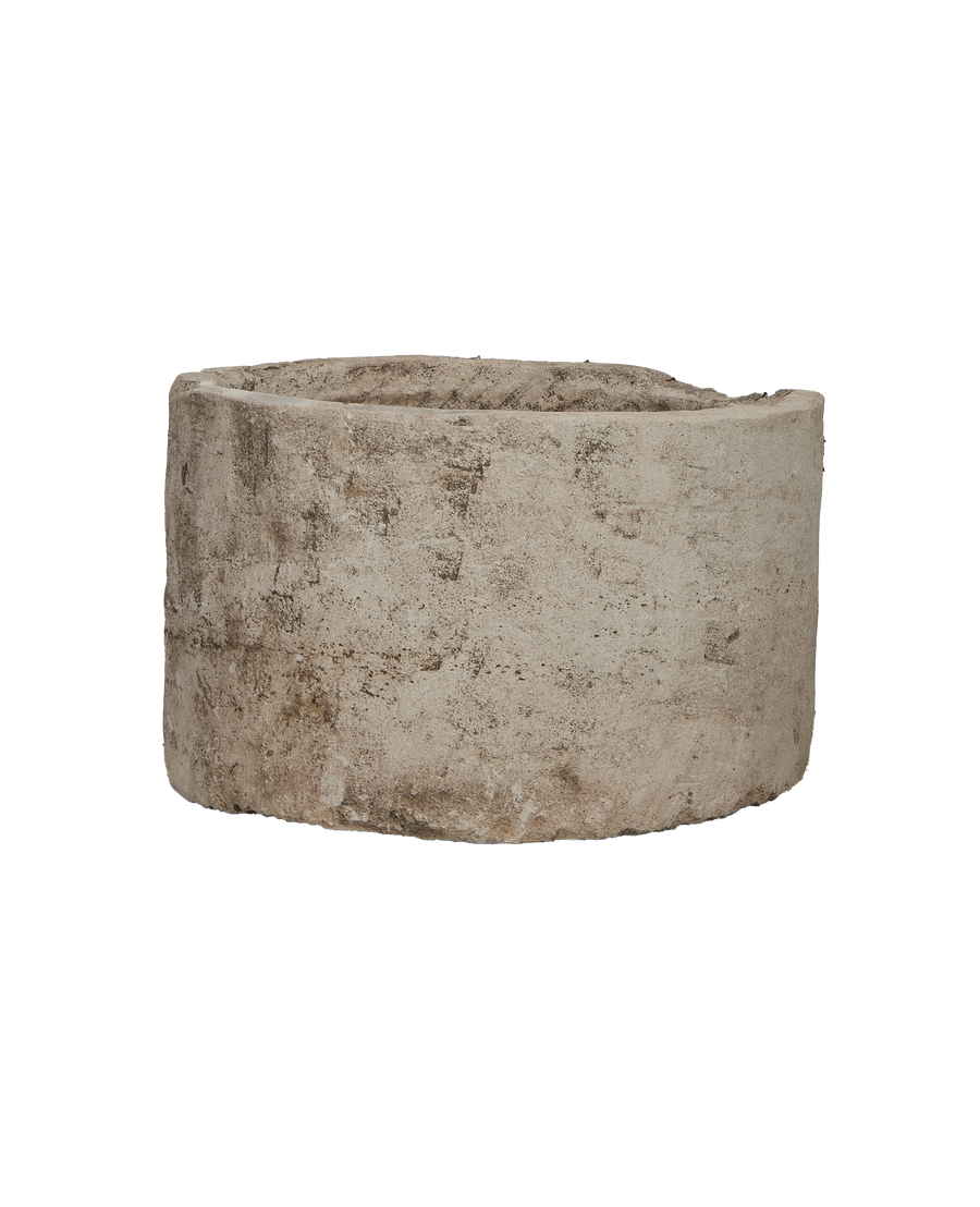 Vintage round Indonesian limestone trough, showing weathered texture and aged patina on its side.