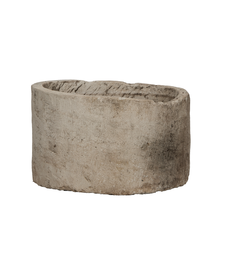 Vintage round Indonesian limestone trough, showing weathered texture from an elevated angle.