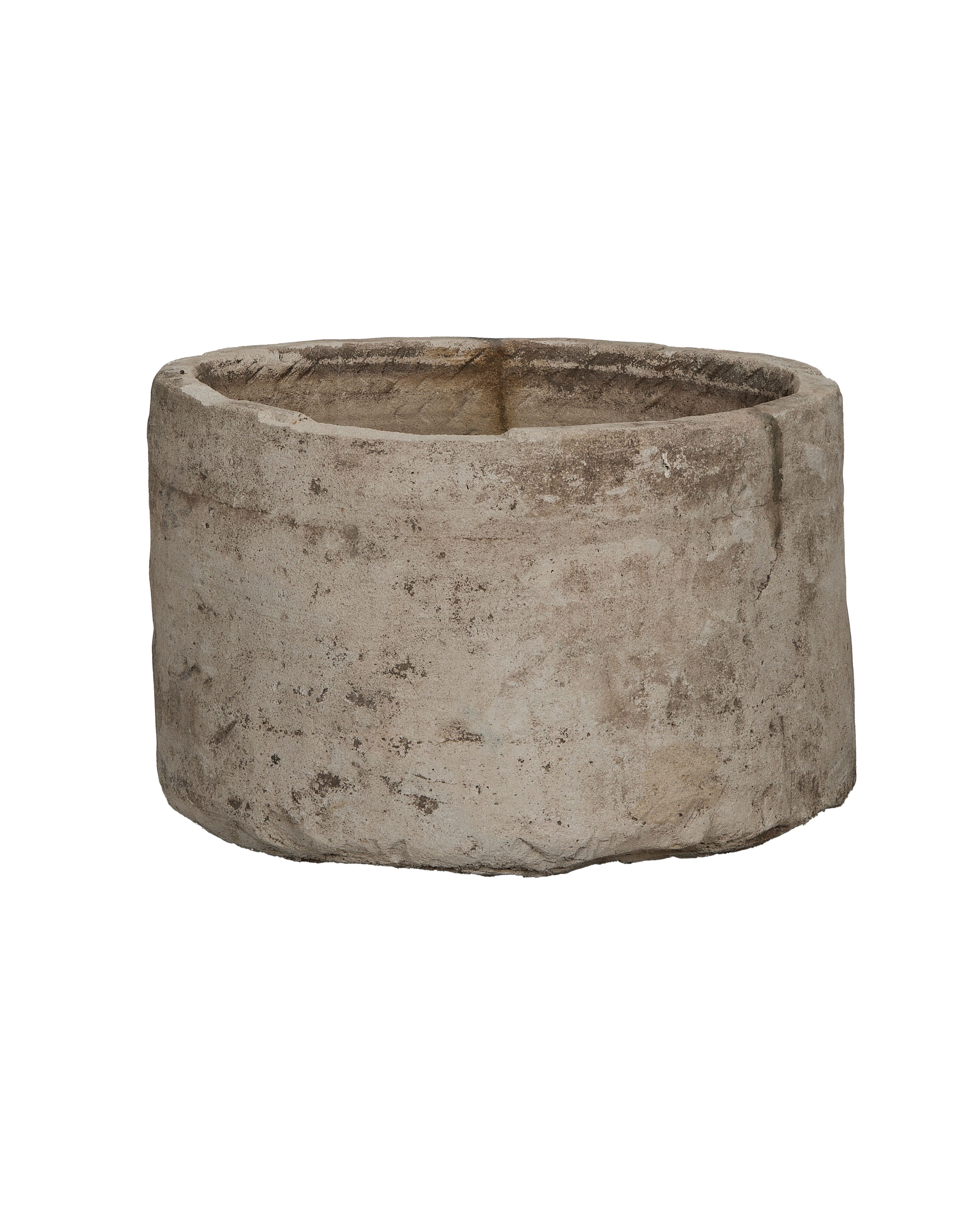 Vintage round limestone trough, side view revealing rustic texture and natural imperfections.