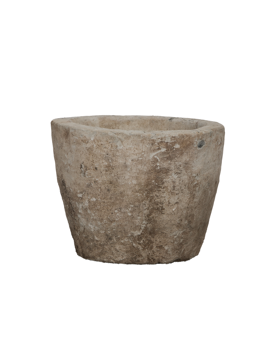 Vintage Indonesian round limestone trough, showing weathered texture from an elevated angle.