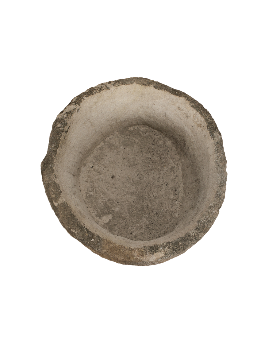 Vintage Indonesian round limestone trough, top-down view showing interior texture and aged patina.