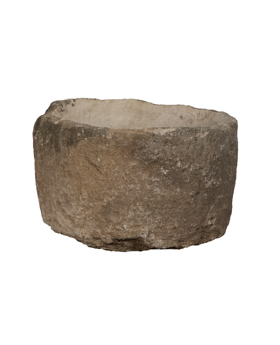 Vintage Indonesian round limestone trough, visible rough texture and weathered edges.