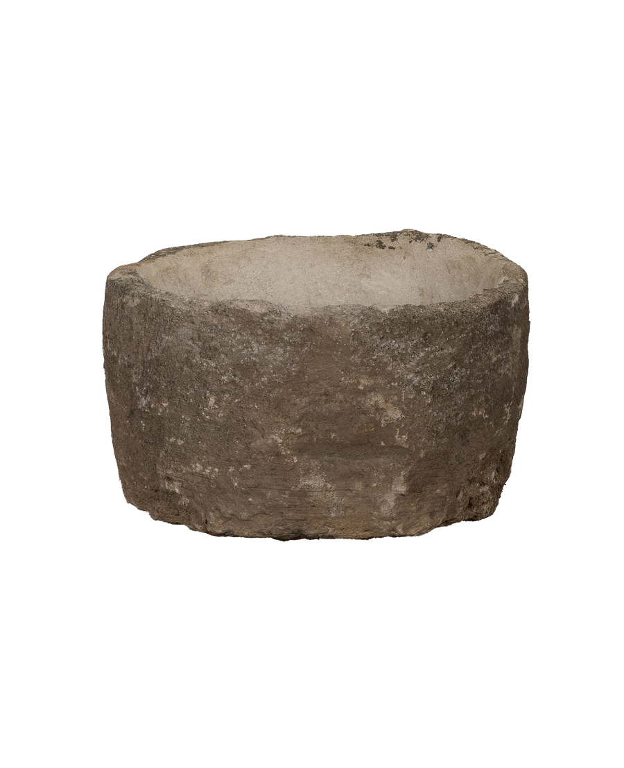 Vintage Indonesian round limestone trough, showing weathered texture and interior basin detail.