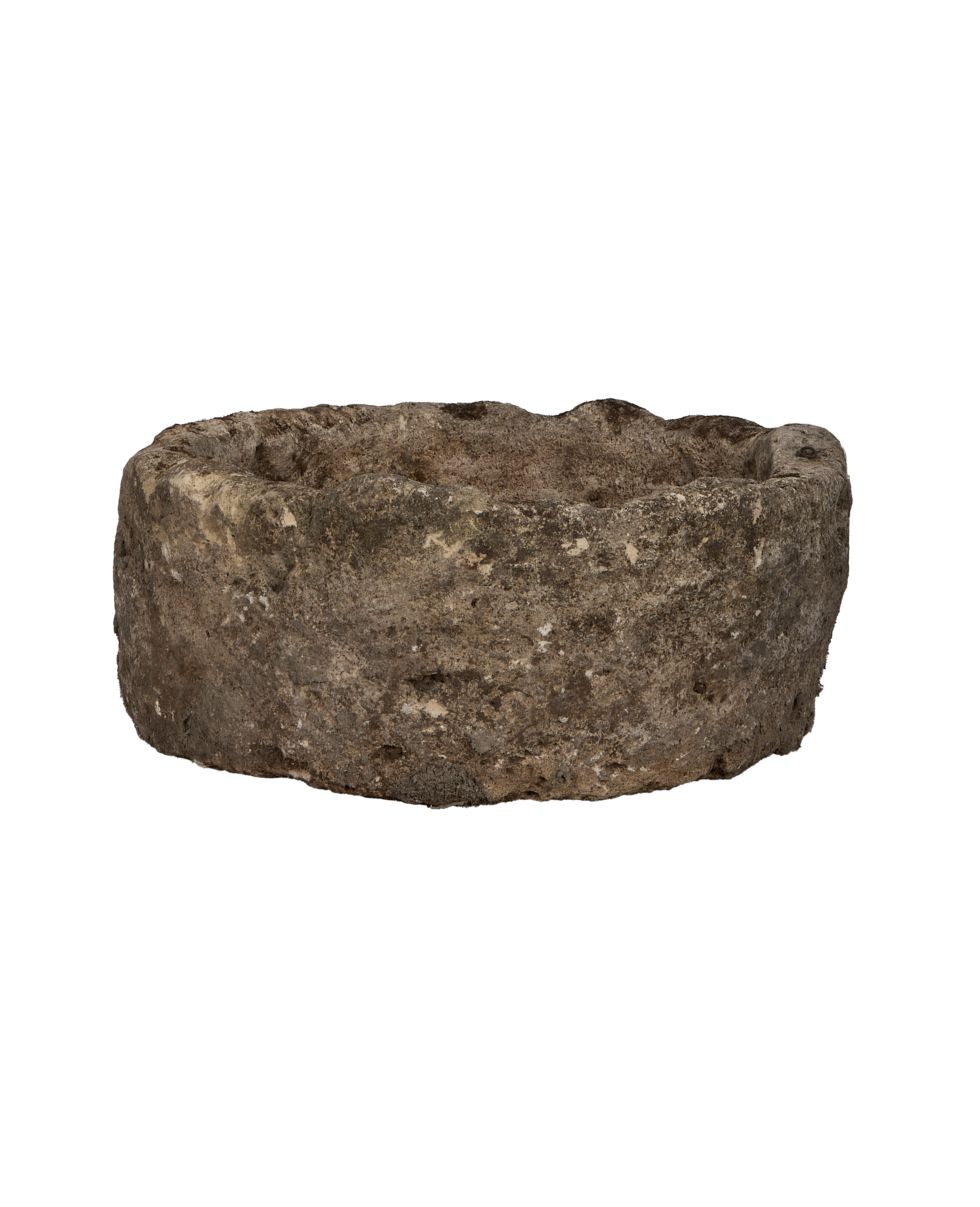 Vintage Indonesian round limestone trough, showing rough weathered exterior and textured rim.