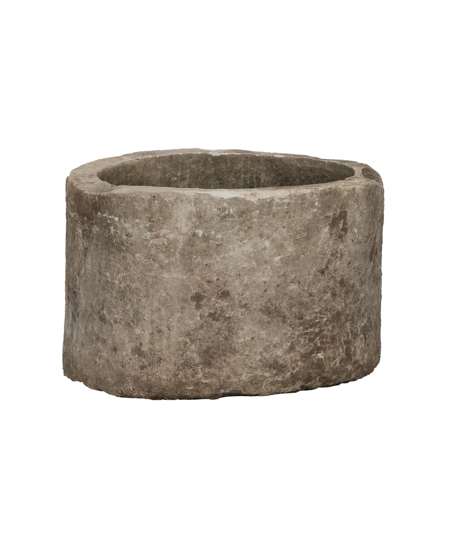 Vintage Indonesian round limestone trough, showing its aged, weathered texture and rustic rim.