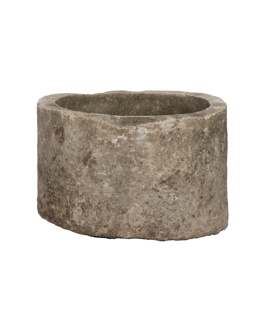 Vintage Indonesian limestone trough, round, showing detailed weathered stone texture.