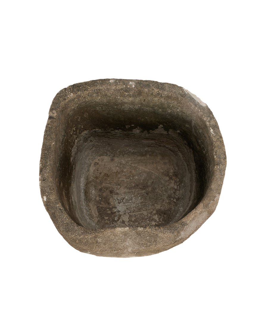 **Vintage Indonesian limestone trough, top-down view showing weathered texture and aged interior.**