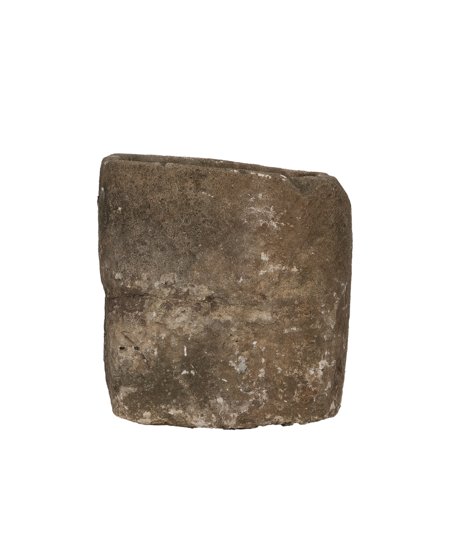 Vintage Indonesian round limestone trough, close-up of textured exterior with natural patina, side view.