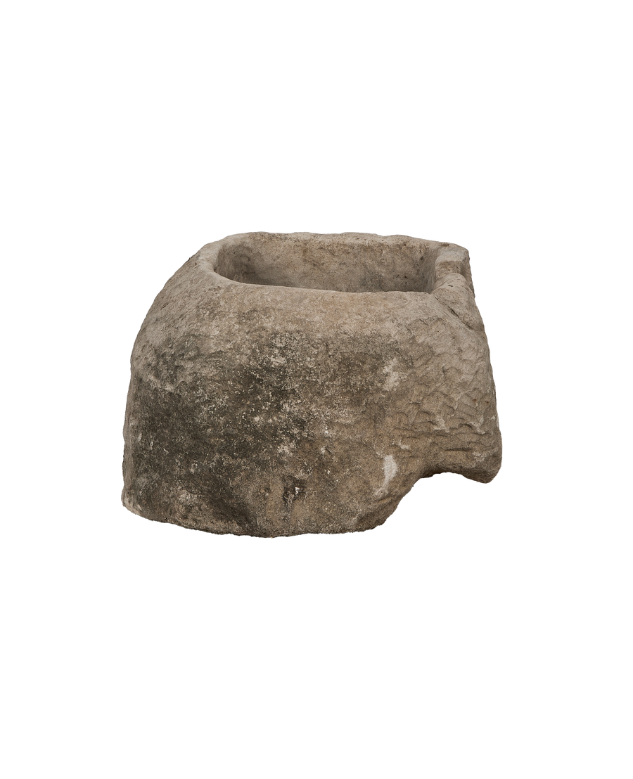Vintage oblong limestone trough from Indonesia, weathered surface texture visible, partial side view.