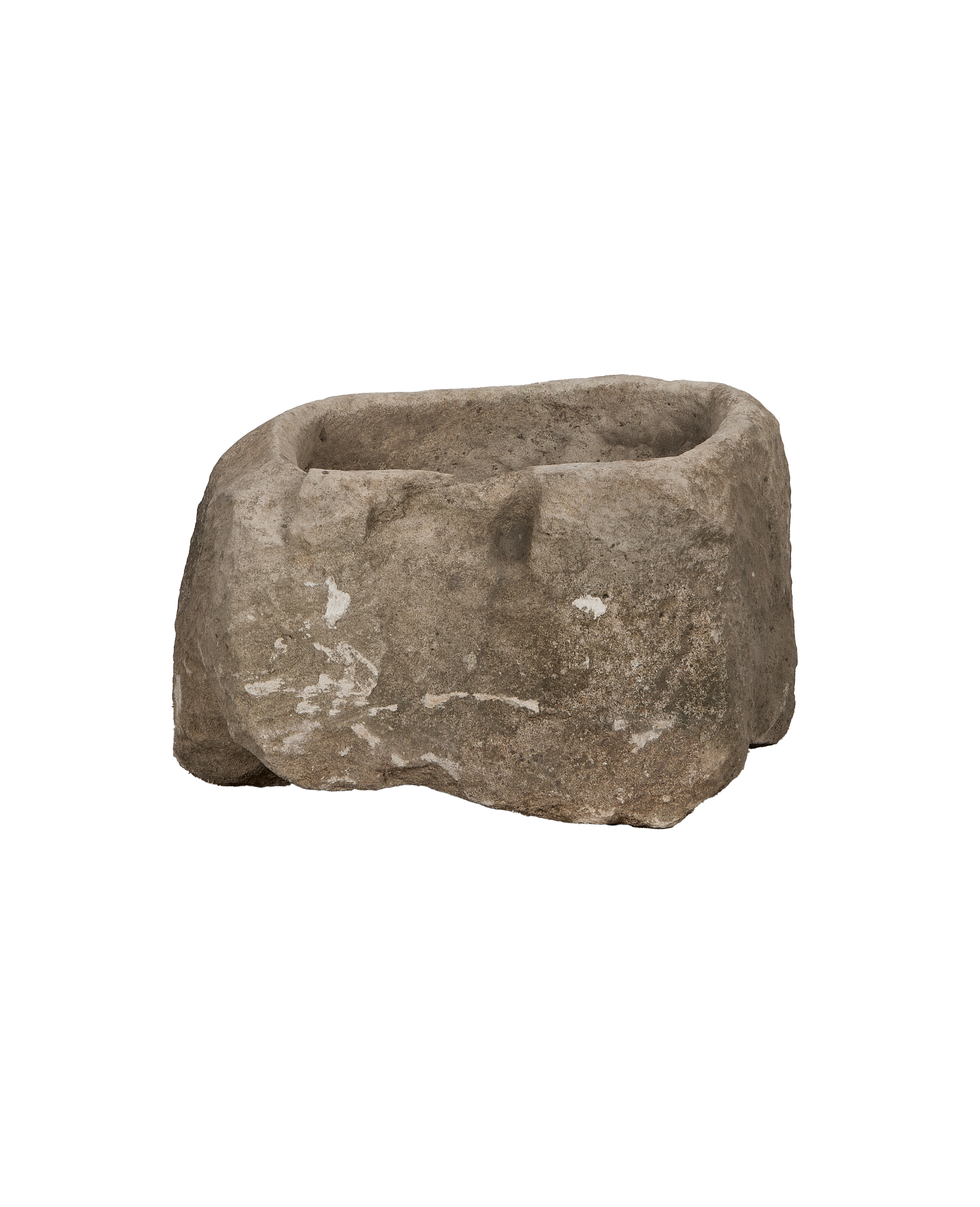 Vintage Indonesian oblong limestone trough, showing its rough texture and weathered details from a side angle.