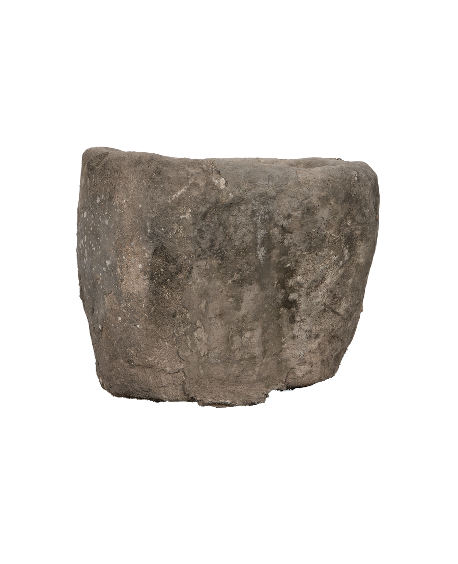 Vintage Indonesian limestone trough, thick oblong shape, side view showing weathered surface texture.