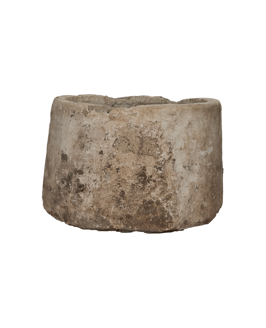 Vintage Indonesian limestone trough, showing its rough, weathered texture and rounded bottom edge.