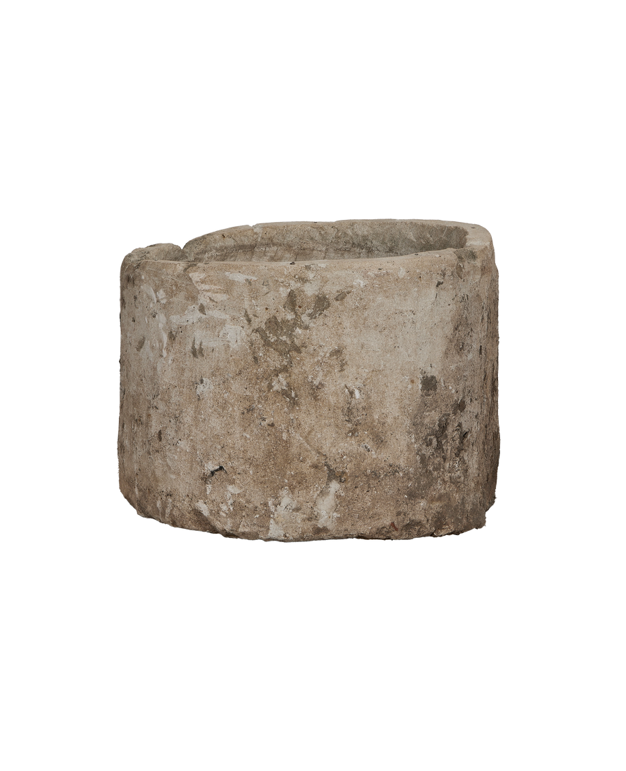 Vintage Indonesian limestone trough, OAK, showing rough weathered texture from side angle.
