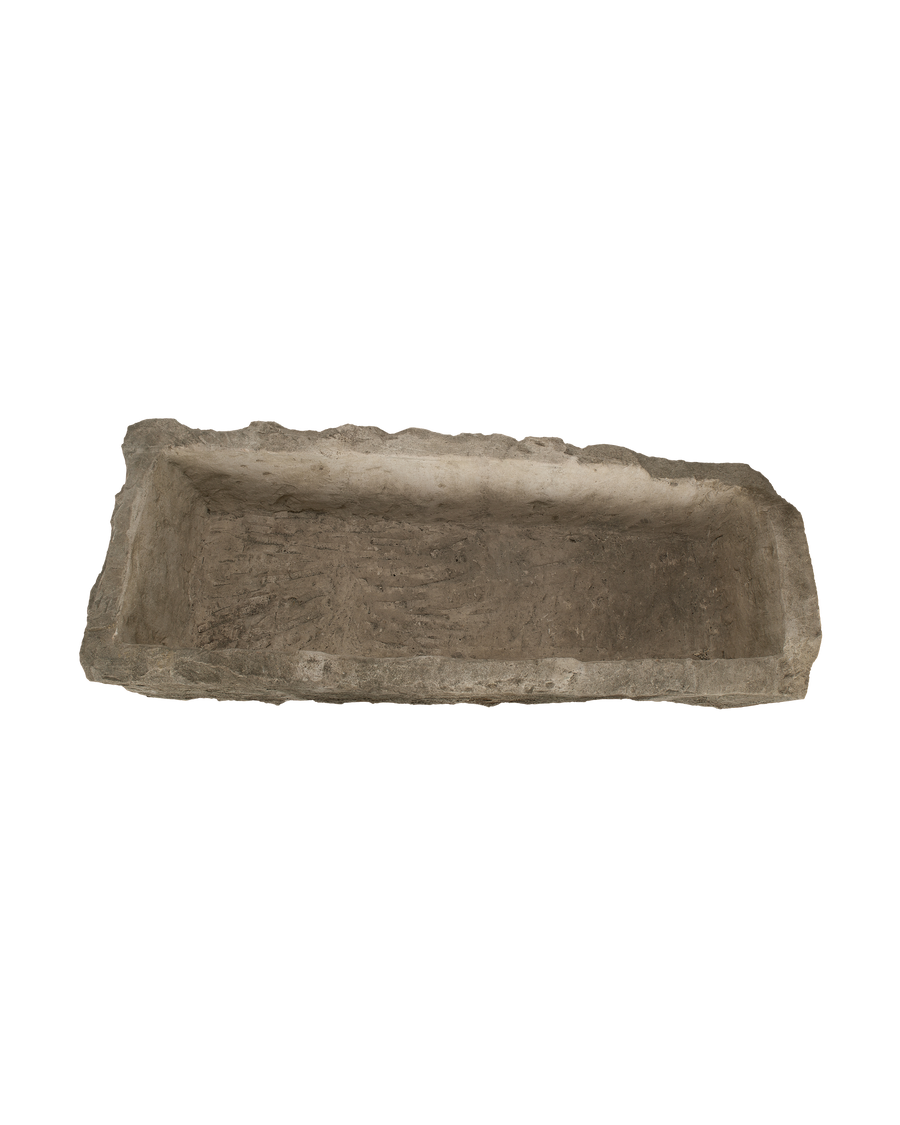 Vintage Indonesian limestone rectangular trough, top-down view showing interior texture and aged rough edges.