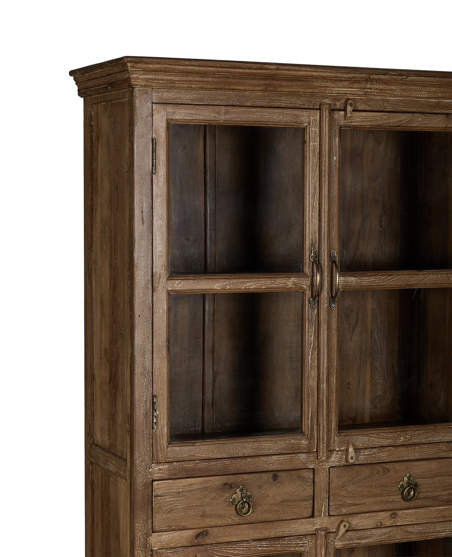 Vintage Indian oak wood cabinet, close-up of glass doors, antique brass handles, worn finish.