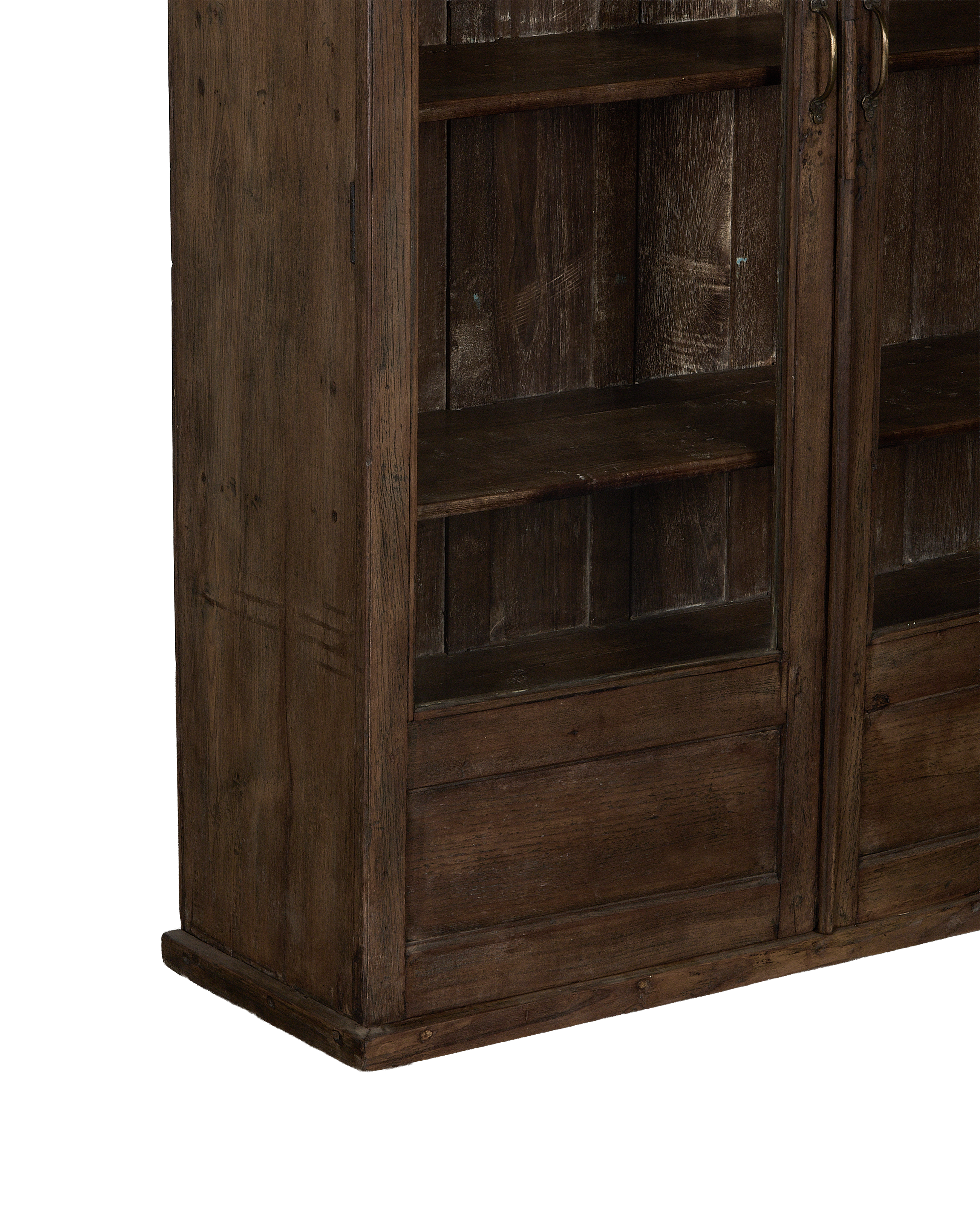 Close-up of vintage Indian oak cabinet's natural wood finish, showing shelves and lower drawers.