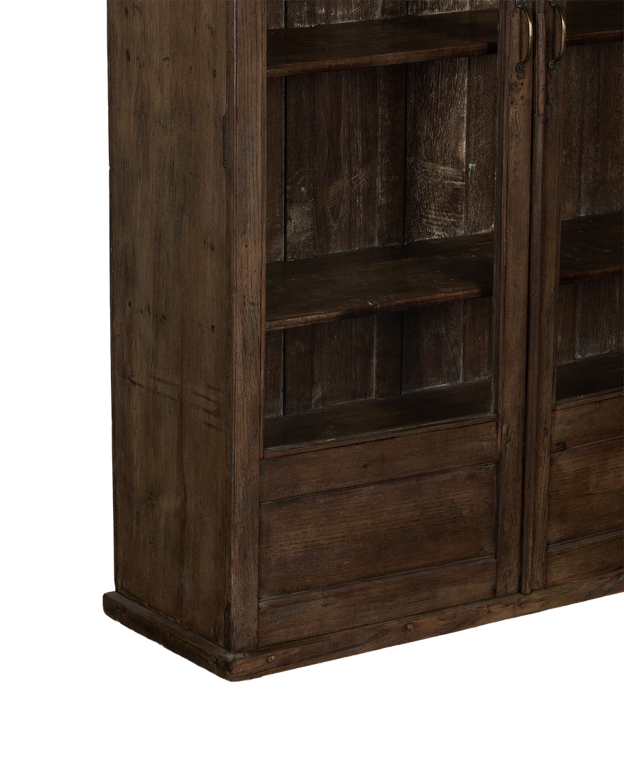 Close-up of vintage Indian oak cabinet's natural wood finish, showing shelves and lower drawers.