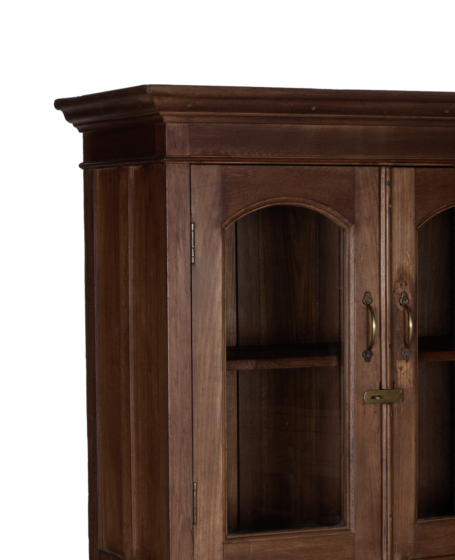 Natural oak vintage Indian cabinet, showing arch glass doors, brass hardware, and intricate molding details.